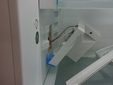 an open refrigerator door with a broken glass door
