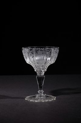 an empty wine glass sitting on top of a black table