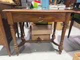 a wooden table with a drawer on top of it