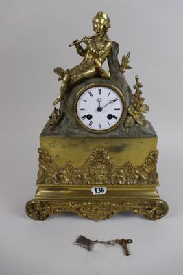 a gold clock sitting on top of a table