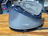 an iron that is sitting on top of a wooden table