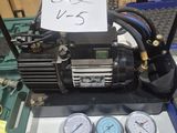 gauges and gauges on a table next to a compressor
