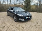 a picture of a car parked in a gravel lot