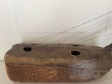 an old wooden boat that is sitting on a table
