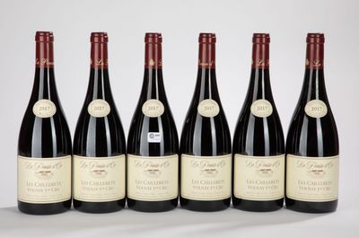 six bottles of red wine lined up in a row