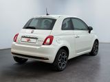 the back of a white fiat car parked in a white room