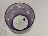 a close up of a purple glass with a bird on it
