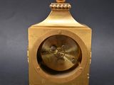 an image of a gold clock on a black background