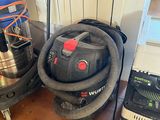 a vacuum and a vacuum cleaner in the corner of a room