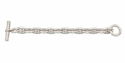 a close up of a silver chain on a white background