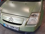 a picture of a green car parked in a garage