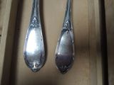 two spoons that are sitting next to each other