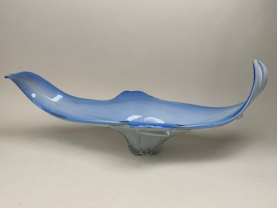 a blue glass bowl sitting on top of a white table
