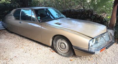 a car that is sitting in the gravel