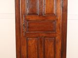 a tall wooden cabinet with a clock on top of it