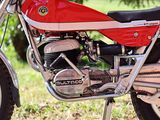a red motorcycle that is parked in the grass