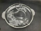 a glass plate with flowers on it on a table