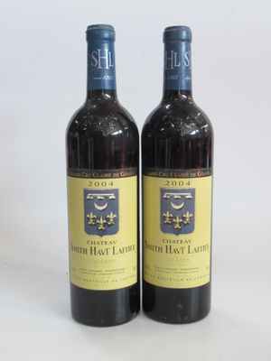 two bottles of wine sitting next to each other on a table