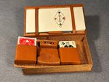 a wooden box with four cards in it on the floor