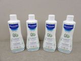 three bottles of moist lotion sitting on a table next to each other