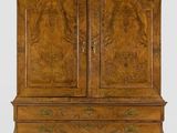 an antique wooden cabinet with two doors and drawers