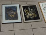 four framed pictures on the floor of a bathroom