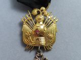 a gold medal with a black ribbon around it