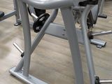 an image of a gym room with a row of exercise machines