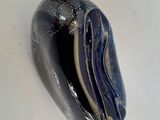 a picture of a black and white marble on a white surface