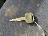 a key on the seat of a car that is missing a keychain