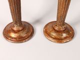 pair of antique brass candlesticks on a white background