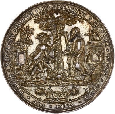 a close up of a silver coin with an image of people on it