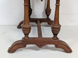a small wooden table with a marble top on it