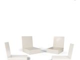 four white chairs and a table on a white surface