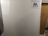 un réfrigérateur-congélateur blanc posé sur une feuille de papier blanche