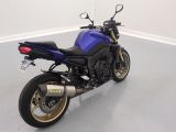 a picture of a blue motorcycle parked in a room