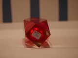 a red dice sitting on top of a white table