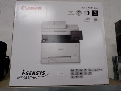 a box of a printer on a shelf in a room