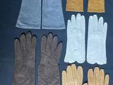 six pairs of gloves are lined up on a black surface