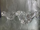 two glass birds that are sitting on a glass table