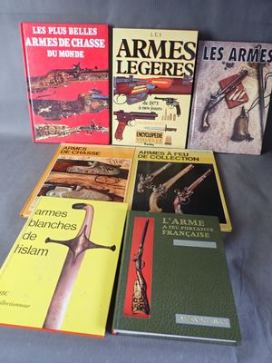 several books of different types of guns are on a gray surface