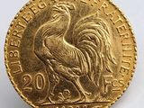 l'image d'une pièce d'or ornée d'un coq
