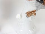 a figurine of a zebra and a bird in a vase