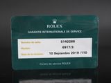 a close up of a green business card with a crown on it