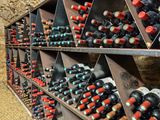 many bottles of wine on the shelves in the wine cellar