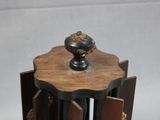 a small wooden table with a vase on top of it