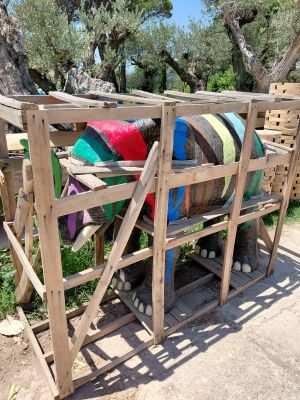 a wooden pallet with a bunch of colorful pillows on it
