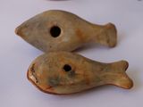 two pieces of pottery sitting on a white surface