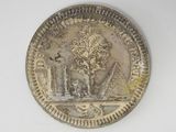 a silver coin with a picture of a man and a woman on it