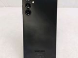 a close up of the back of a black samsung phone